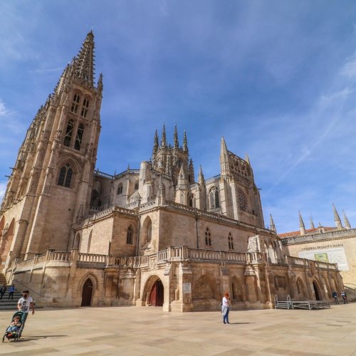 Explore the magnificent Burgos Cathedral in Spain, showcasing Gothic architecture under a clear blue sky.